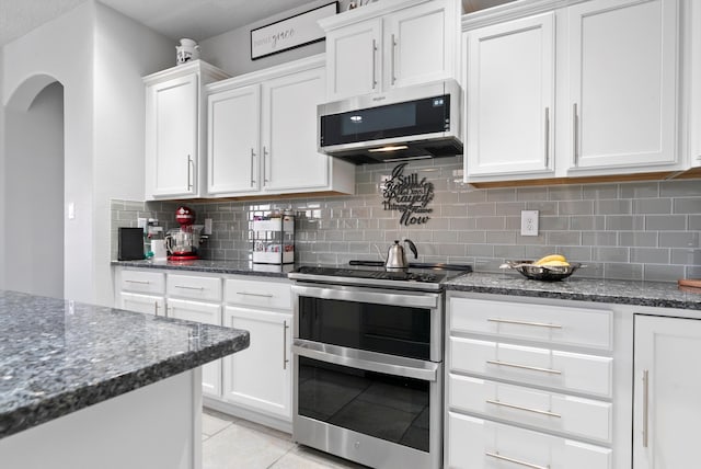 kitchen featuring white cabinets, stainless steel appliances, and backsplash