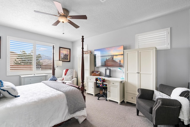 bedroom featuring carpet, ceiling fan, and a textured ceiling