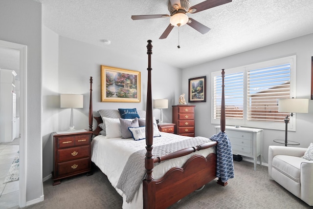 bedroom featuring carpet floors, ceiling fan, baseboards, and a textured ceiling