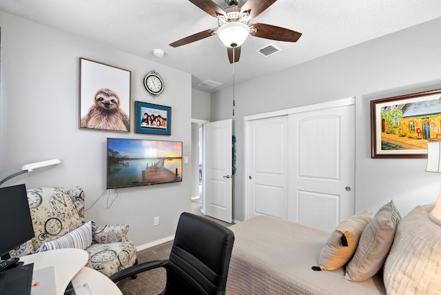 bedroom featuring baseboards, visible vents, ceiling fan, carpet, and a closet