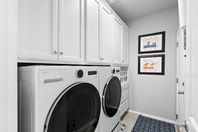 laundry area with washing machine and dryer, cabinet space, baseboards, and light tile patterned flooring