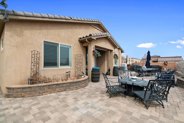 view of patio / terrace featuring fence and outdoor dining area