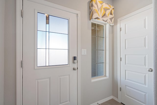 doorway to outside with baseboards