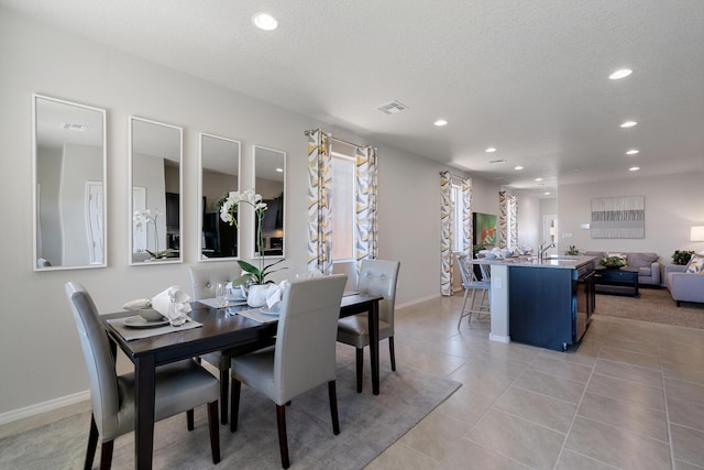 dining room featuring light tile patterned floors, a textured ceiling, visible vents, and recessed lighting