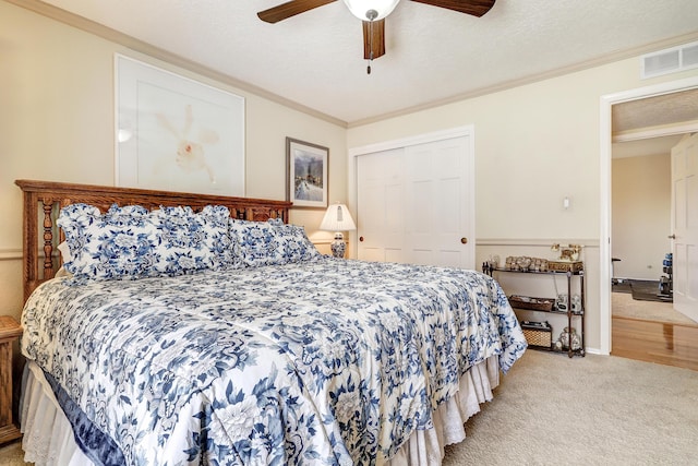 bedroom with ornamental molding, a closet, and visible vents