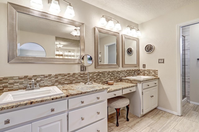 full bathroom with baseboards, vanity, decorative backsplash, and a textured ceiling