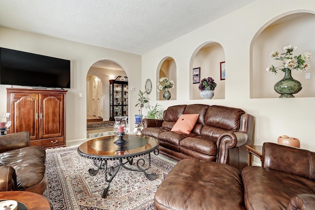 living area with a textured ceiling