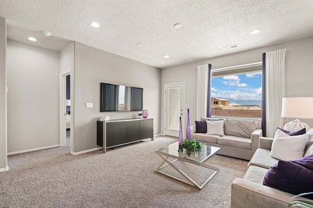 carpeted living room with a textured ceiling, recessed lighting, visible vents, and baseboards