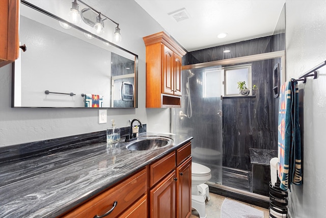 full bathroom with visible vents, toilet, a stall shower, vanity, and tile patterned floors