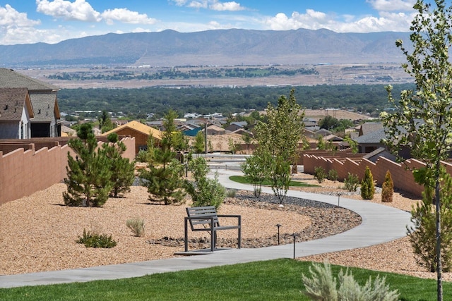 view of property's community featuring a residential view, fence, and a mountain view