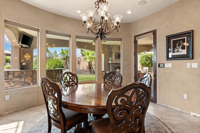 dining space with recessed lighting, a fireplace, baseboards, and light tile patterned floors