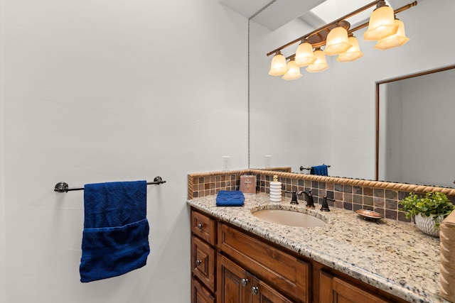 bathroom with decorative backsplash and vanity