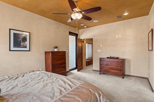 bedroom with light carpet, ceiling fan, visible vents, and baseboards