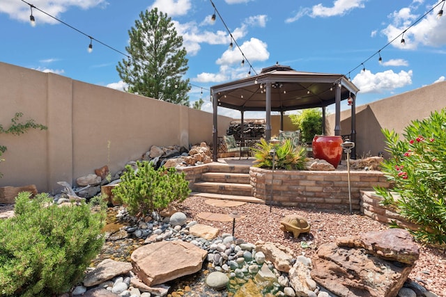 view of yard with a gazebo and a fenced backyard