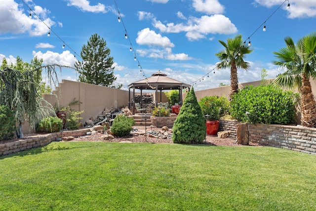 view of yard featuring a gazebo and a fenced backyard