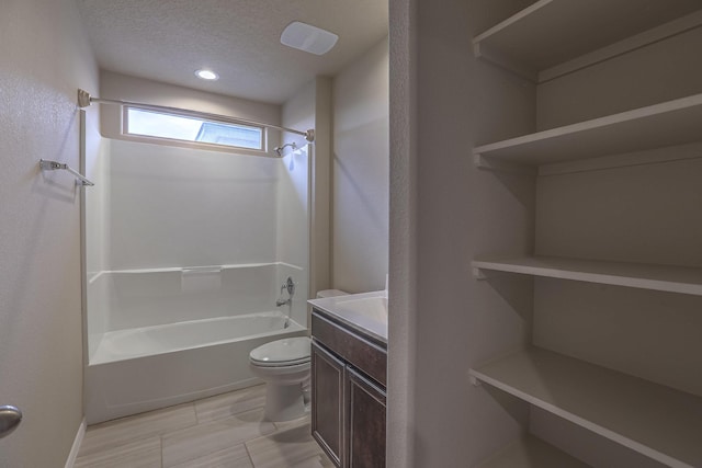 full bathroom with a textured ceiling, toilet, bathtub / shower combination, and vanity