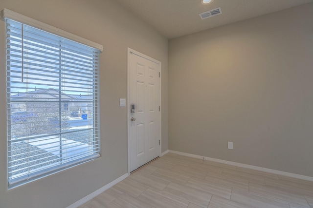 entryway featuring baseboards and visible vents