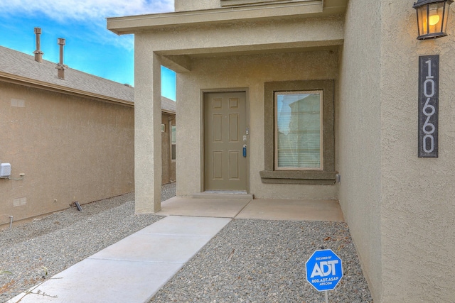 doorway to property with a patio area and stucco siding