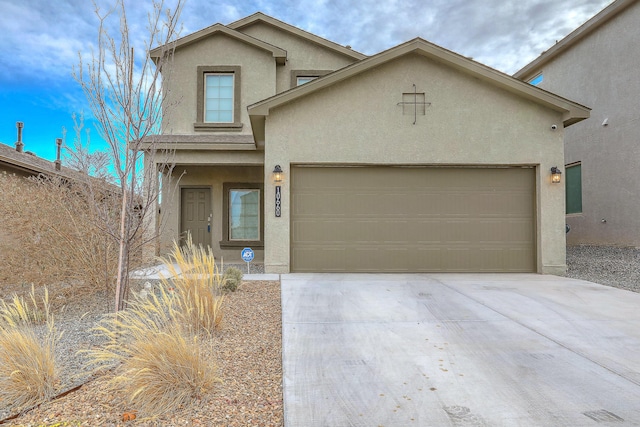 view of front of property with a garage, concrete driveway, and stucco siding