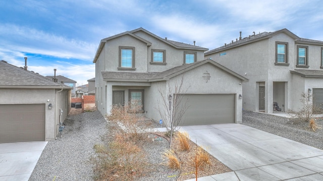 traditional home with driveway, a garage, and stucco siding