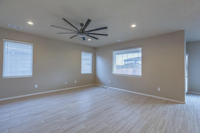 unfurnished room featuring a ceiling fan, recessed lighting, visible vents, and baseboards