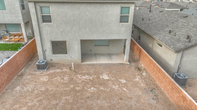 back of property with a patio, fence, cooling unit, and stucco siding