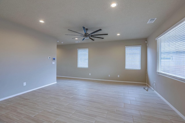 empty room featuring ceiling fan, recessed lighting, visible vents, and baseboards