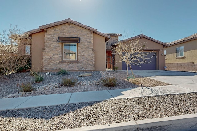 view of front of house featuring a tiled roof, stucco siding, a garage, stone siding, and driveway