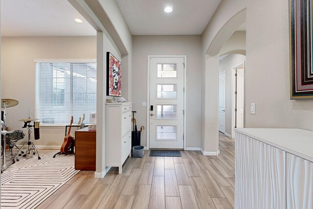 9020 Retablo Rd NW, Albuquerque, NM 87120 - entryway featuring arched walkways, baseboards, recessed lighting, and light wood-style floors