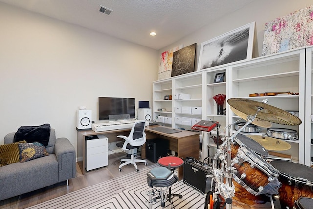 office area with recessed lighting, wood finished floors, visible vents, and a textured ceiling