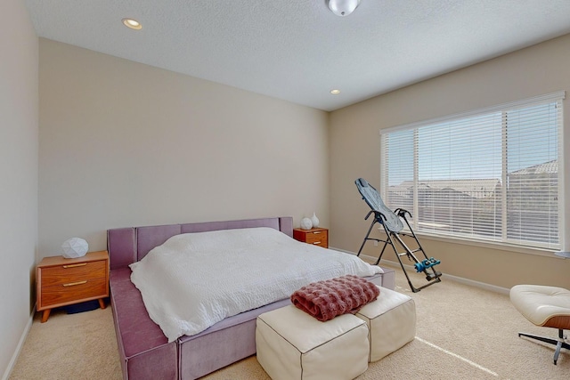 bedroom with recessed lighting, baseboards, carpet floors, and a textured ceiling