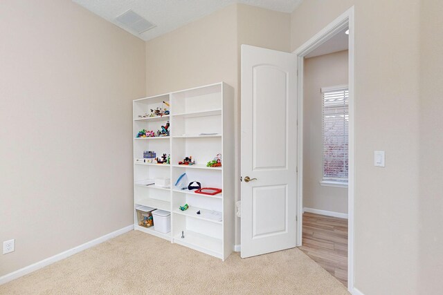 9020 Retablo Rd NW, Albuquerque, NM 87120 - rec room with baseboards, carpet, and visible vents