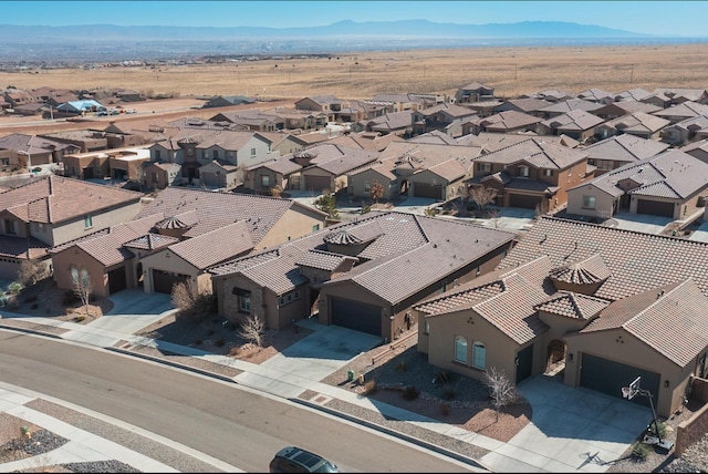 birds eye view of property with a mountain view and a residential view