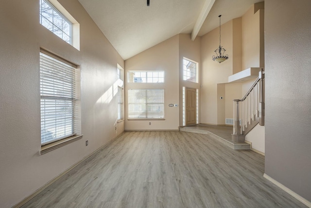 foyer entrance with a wealth of natural light, stairway, and wood finished floors