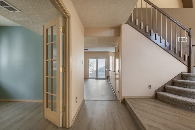 interior space with visible vents, baseboards, and wood finished floors