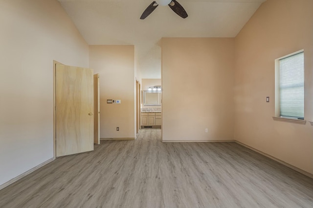 unfurnished room featuring a ceiling fan, lofted ceiling, light wood-style flooring, and baseboards