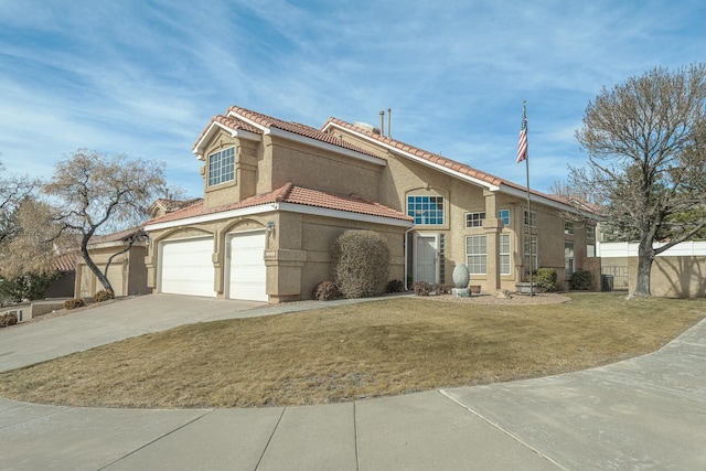 mediterranean / spanish-style house with fence, a tile roof, driveway, stucco siding, and a front yard