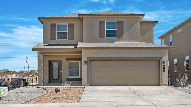 traditional home featuring fence, stucco siding, an attached garage, and concrete driveway