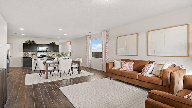 living room featuring baseboards, a textured ceiling, wood tiled floor, and recessed lighting