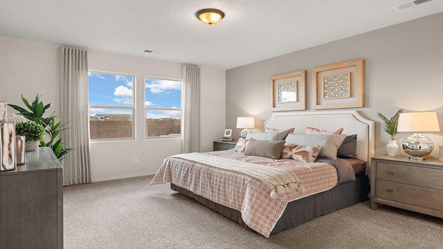 bedroom featuring baseboards, visible vents, carpet floors, and a textured ceiling