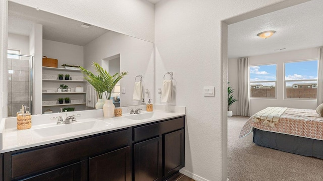 full bath featuring double vanity, ensuite bath, a sink, and a textured ceiling