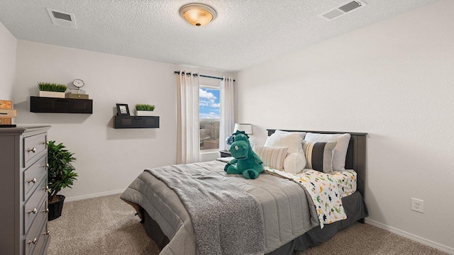 carpeted bedroom featuring baseboards, visible vents, and a textured ceiling