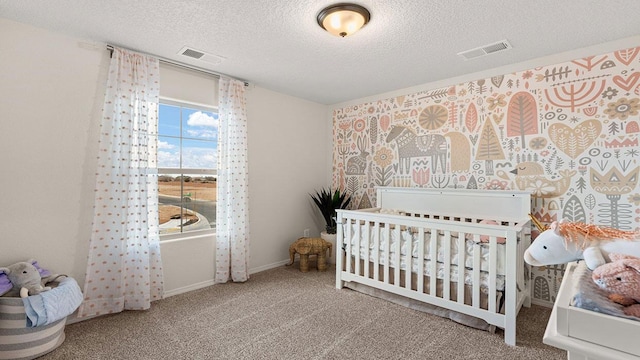 carpeted bedroom with a textured ceiling, baseboards, and visible vents