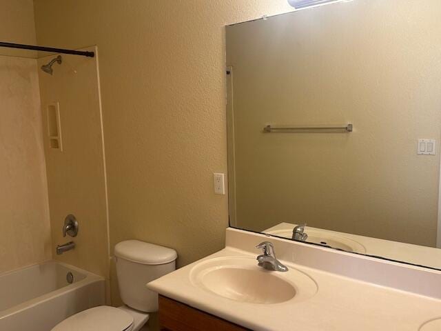 full bath with a textured wall, vanity, toilet, and bathing tub / shower combination