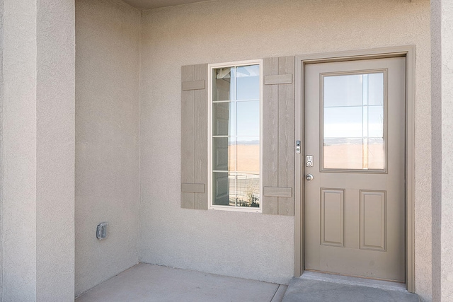 property entrance featuring stucco siding