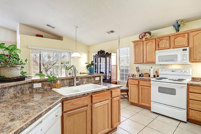 kitchen featuring light tile patterned floors, visible vents, vaulted ceiling, a sink, and white appliances