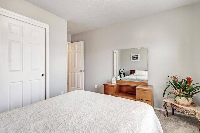 bedroom with a textured ceiling and carpet flooring