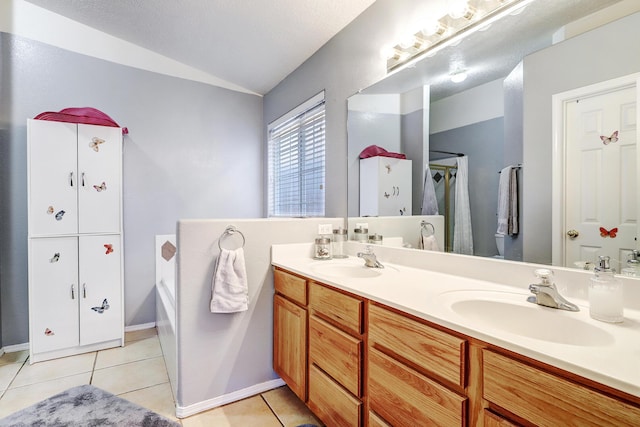 full bath featuring a washtub, tile patterned flooring, and a sink