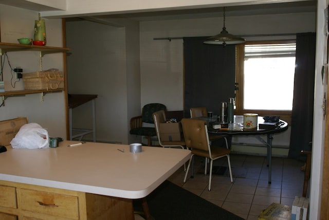 interior space with a baseboard heating unit and light tile patterned floors