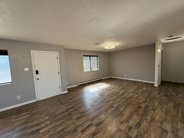 unfurnished living room with a healthy amount of sunlight, a baseboard radiator, visible vents, and dark wood-style flooring